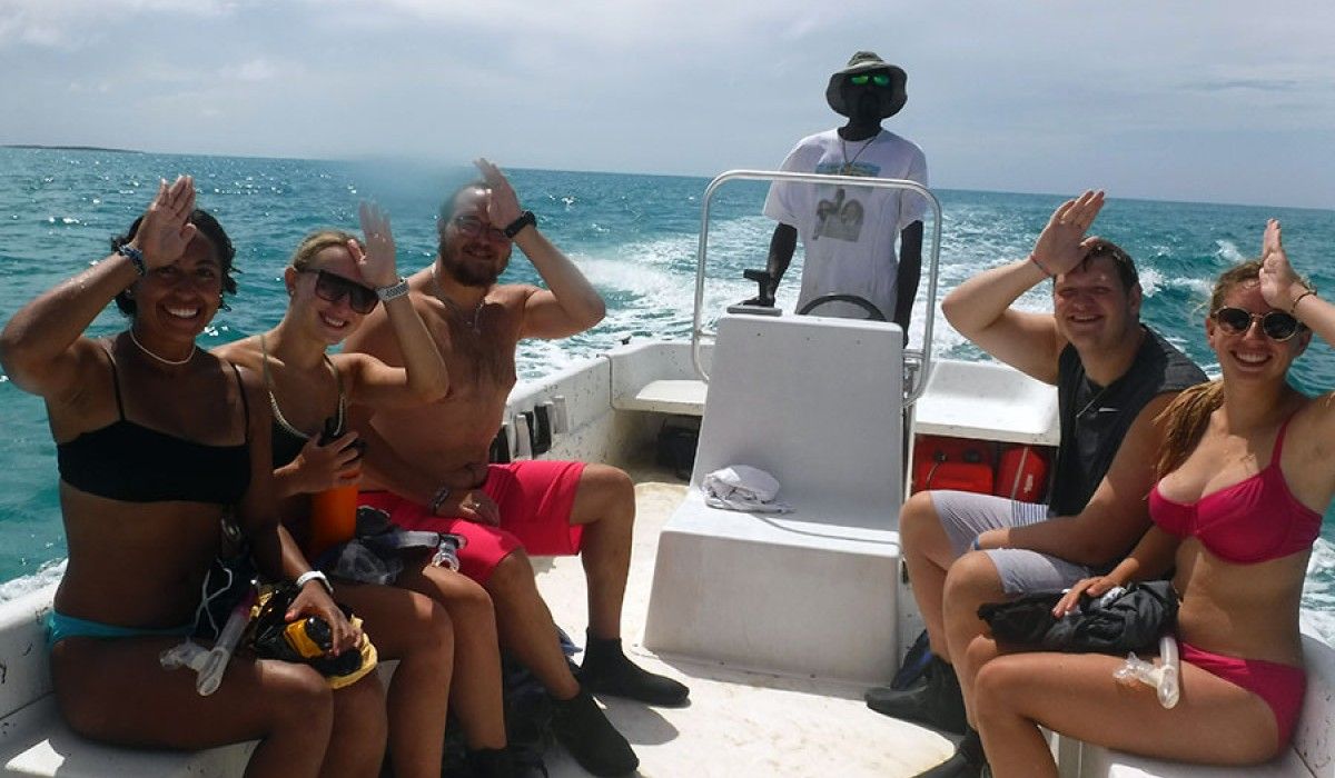 the boat crew giving the shark signal after their snorkel