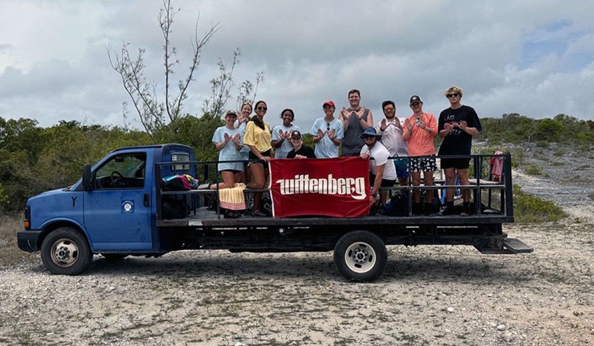 students on a truck holding a wittenberg flag